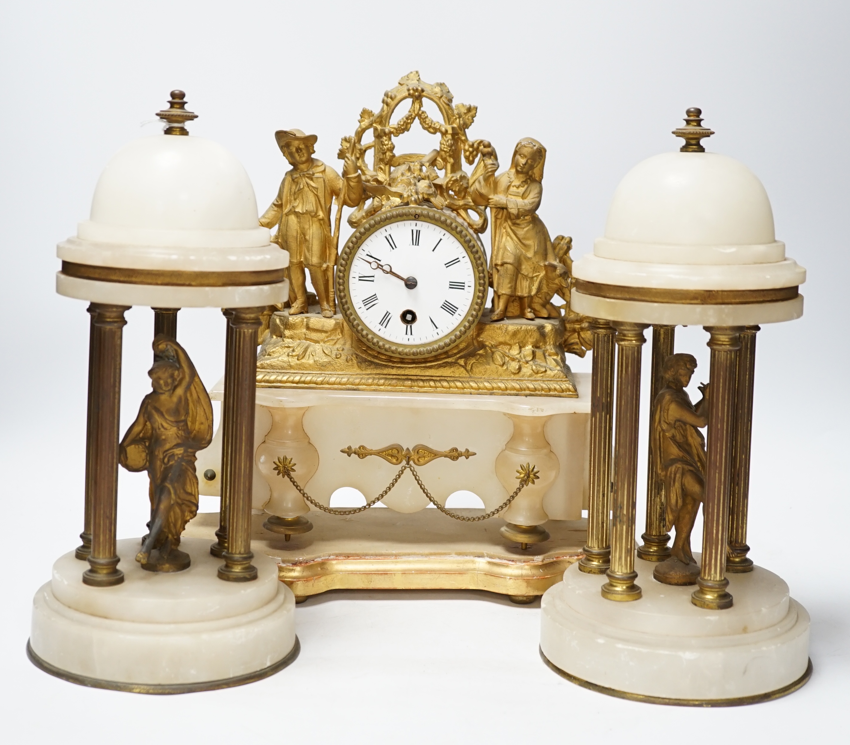 A French spelter and alabaster figural clock garniture, clock 23cm high